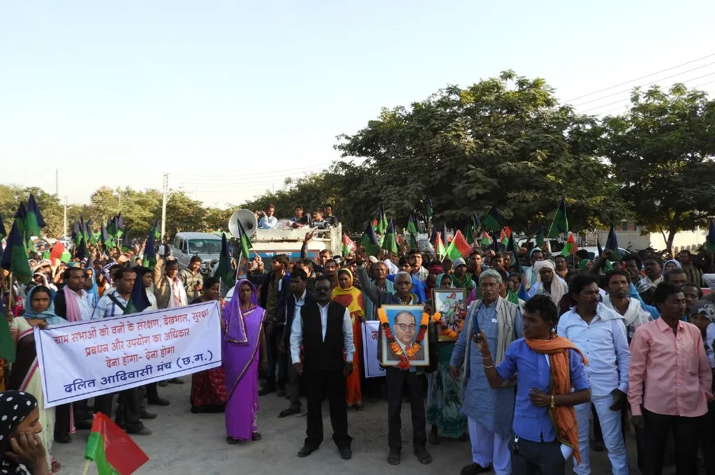 members of Dalit Adivasi Manch protesting for gram sabhas' forest rights, with one protestor holding up a photo of DR B R Ambedkar and some other protesters holding up a banner--Dalit and Adivasi rights