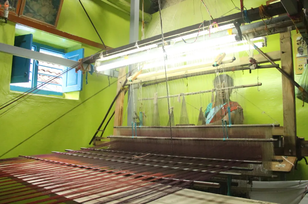a woman weaving a negamam saree--negamam saree