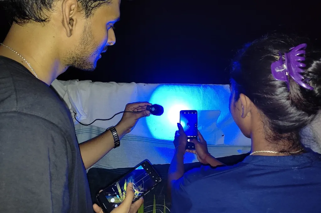 A child in Panicherra using a moth screen to document insect diversity--citizen science