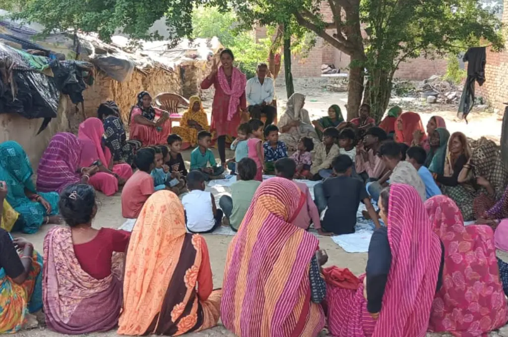 a crowd of people gathered in a large circle and listening to a female speaker--Sahariyas