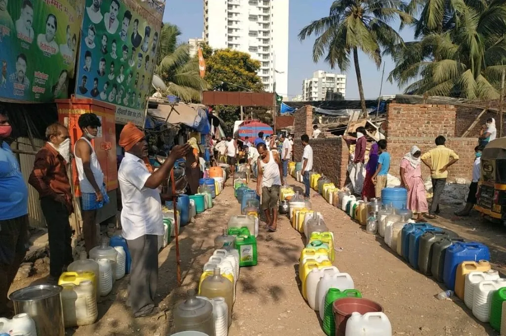 several rows of plastic containers filled with water with people standing around them--social movements