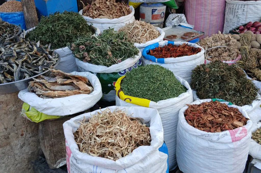 Small market stall displaying open sacks filled with different varieties of Hokh Syun arranged outside a shop--Hokh Syun