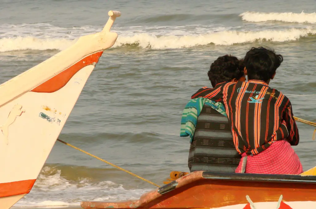 two adolescent boys on the beach next to boats--juvenile justice