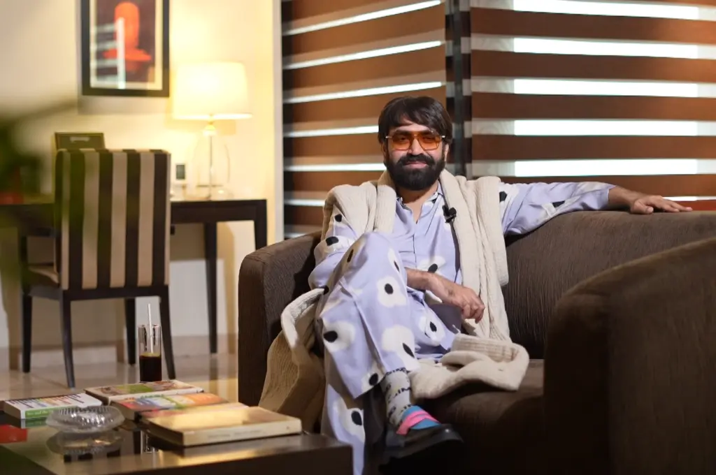 keshav suri, executive director at The Lalit Suri Hospitality Group and founder of the Keshav Suri Foundation, sitting cross-legged on a sofa--queer activism