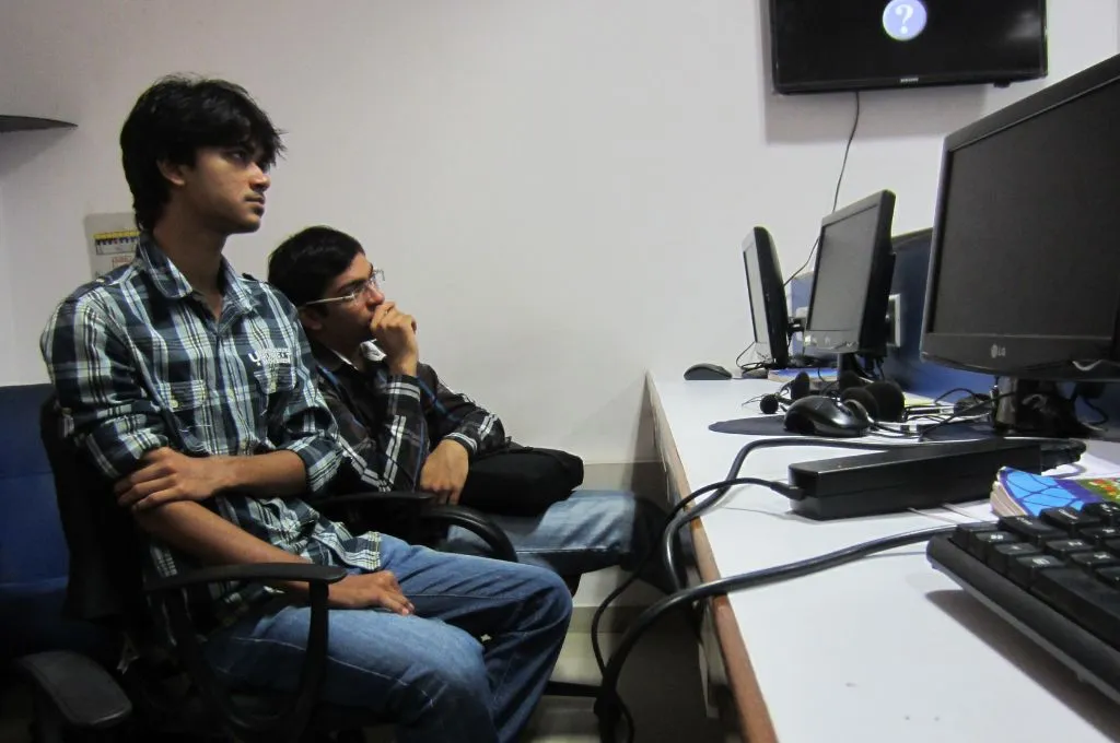 two young men looking at desktop monitors--social sector recruitment