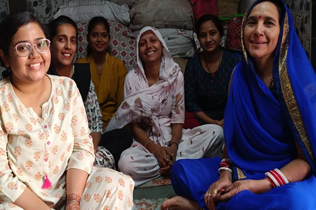 a group of women sitting on the floor and smiling at the camera--palliative care