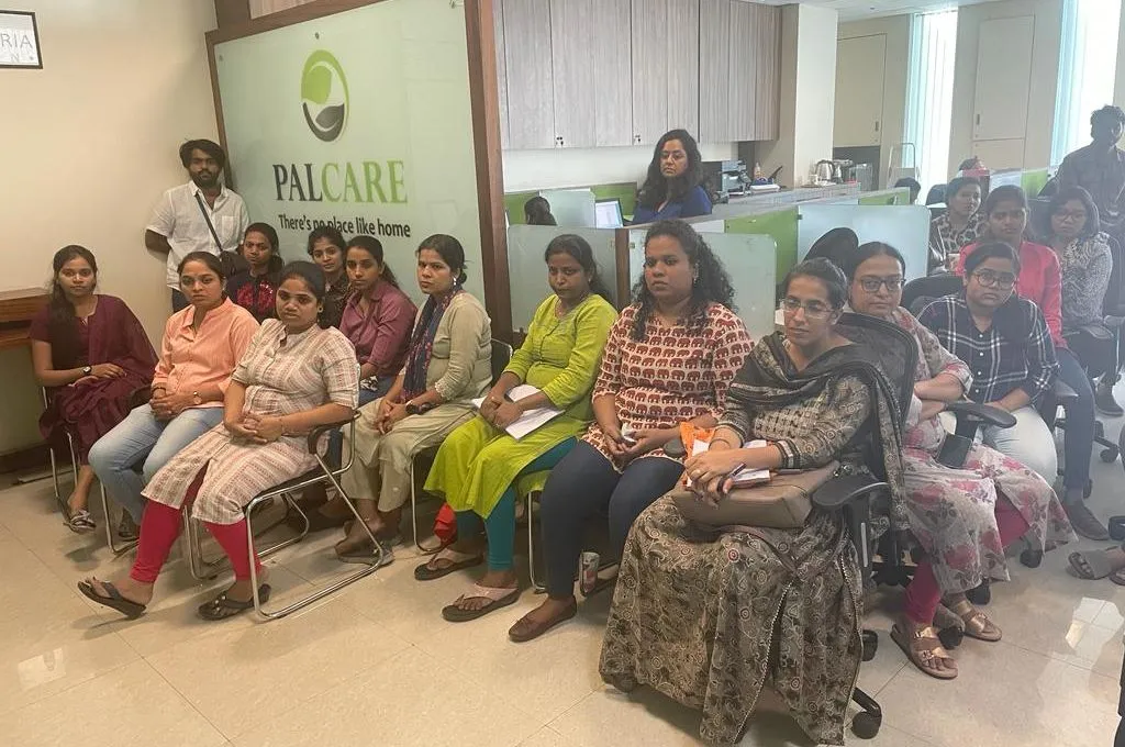 a large group of women sitting in the waiting room of the Palcare office--palliative care