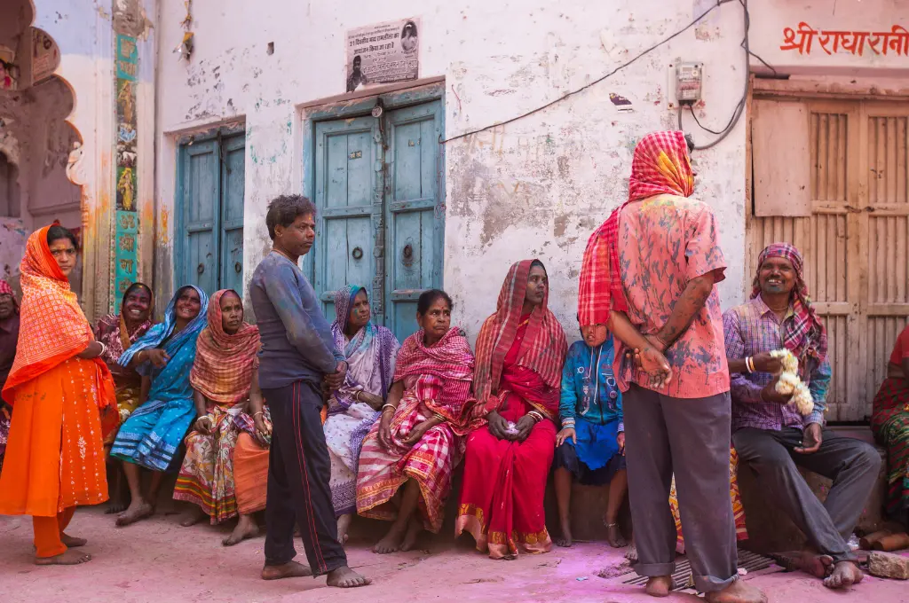 a group of people standing beside a white concrete building--social justice framework