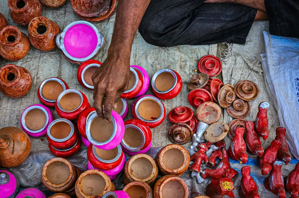 handcrafted colourful clay pots and figurines displayed at an outdoor market--Dastkar