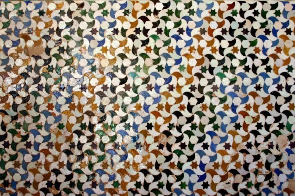 colorful geometric mosaic with interlocking shapes and small stars--Akhila Sivadas