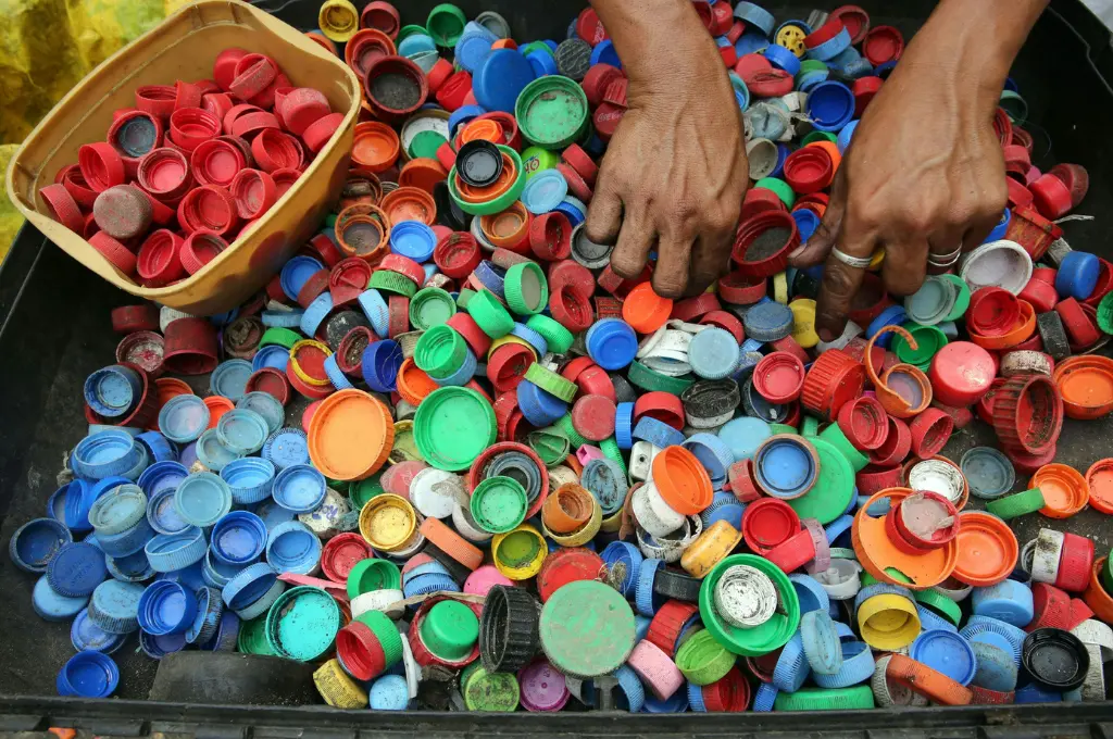 close-up shot of a person's hands sorting multi-coloured plastic bottle caps--nonprofit data strategy