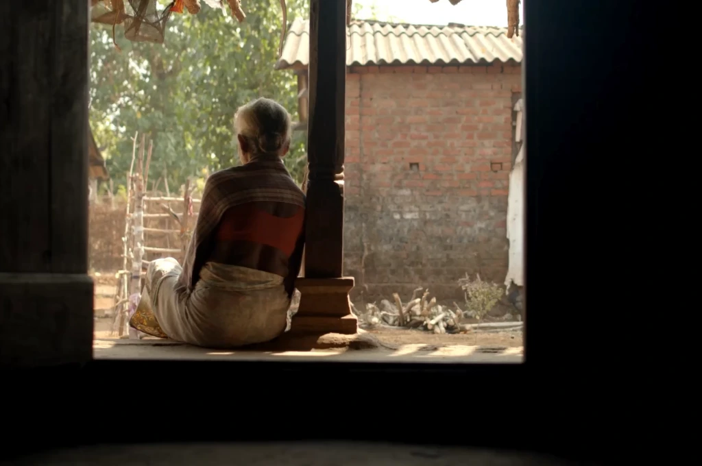 a woman sitting on a platform, leaning against a pillar--migration