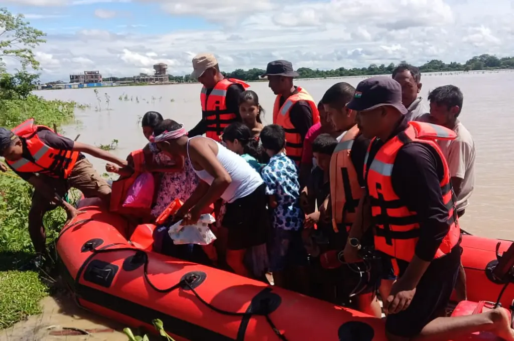 people getting off a rescue raft during the 2026 Assam flood relief operation--Assam floods