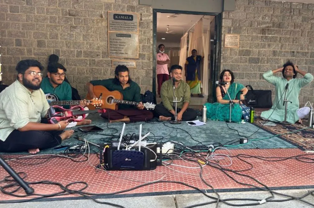 a band of musicians sitting on the floor--hospice facilities