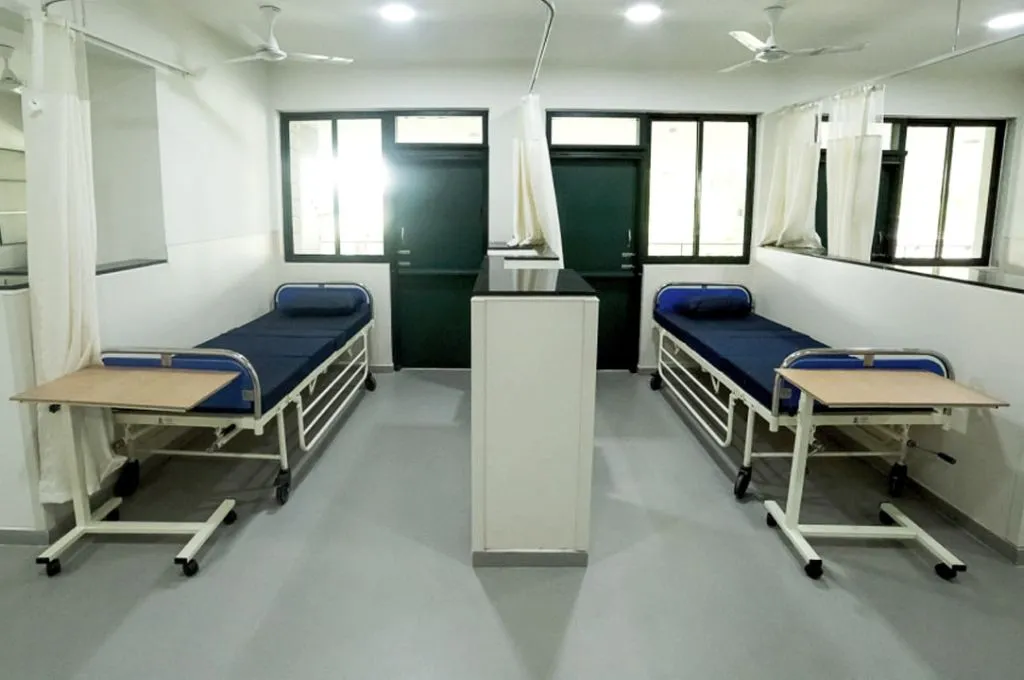 two single beds in a ward with a half wall in between--hospice facilities