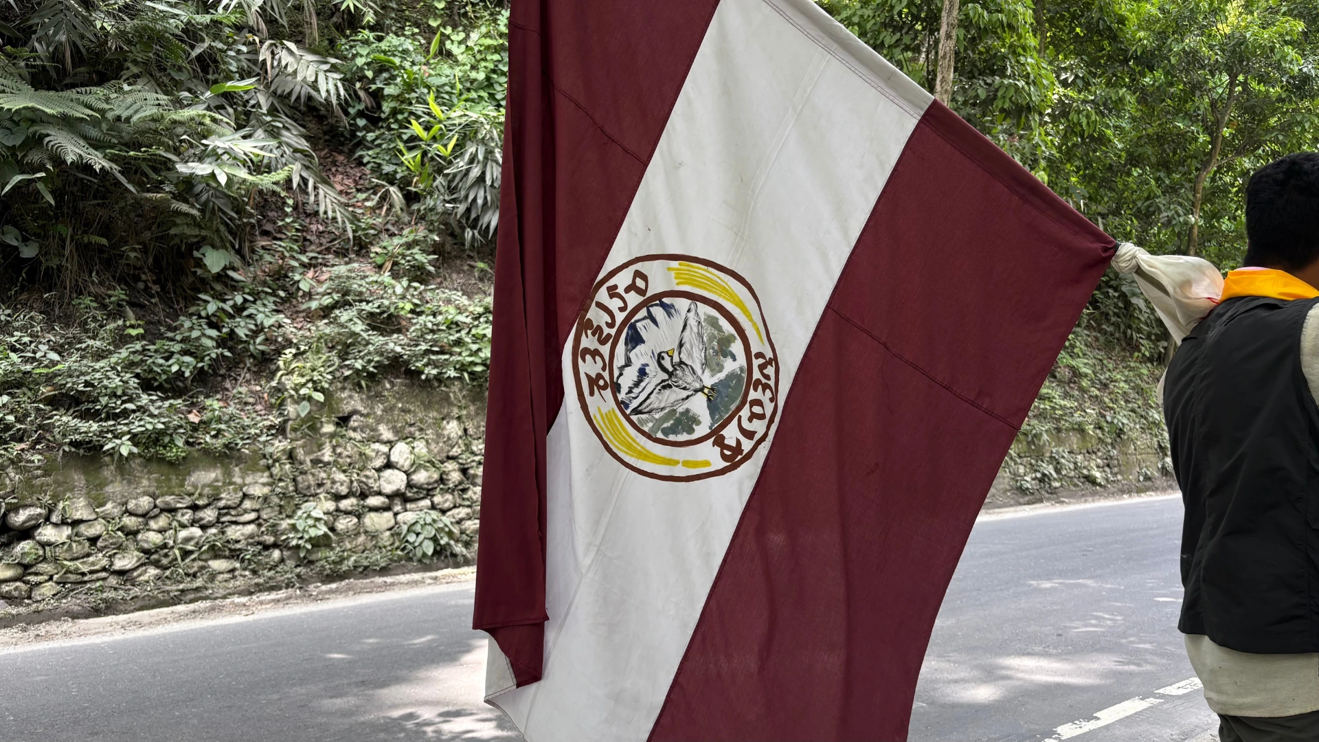 a man carrying a Lepcha flag on his shoulder--Teesta hydropower projects
