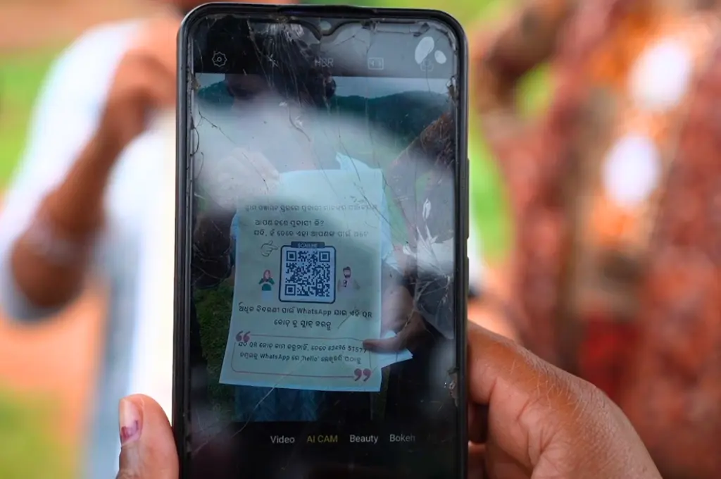 a woman holding up a smartphone to display a QR code--WhatsApp registry