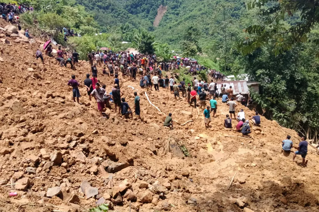 A crowd of people gathered on a hill during rescue operations after a flood--Nagaland floods