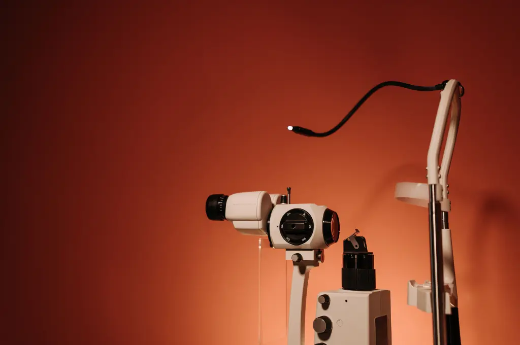 A slit lamp with fine optics against a brown background--health tech