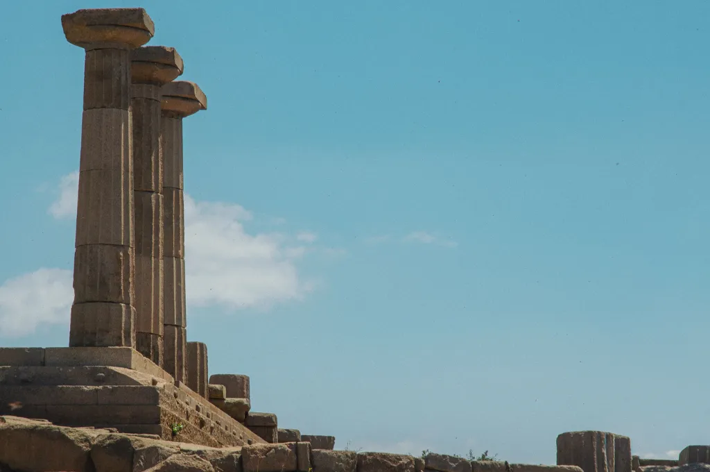 Columns at Assos Temple of Athena under clear blue sky--systems change government