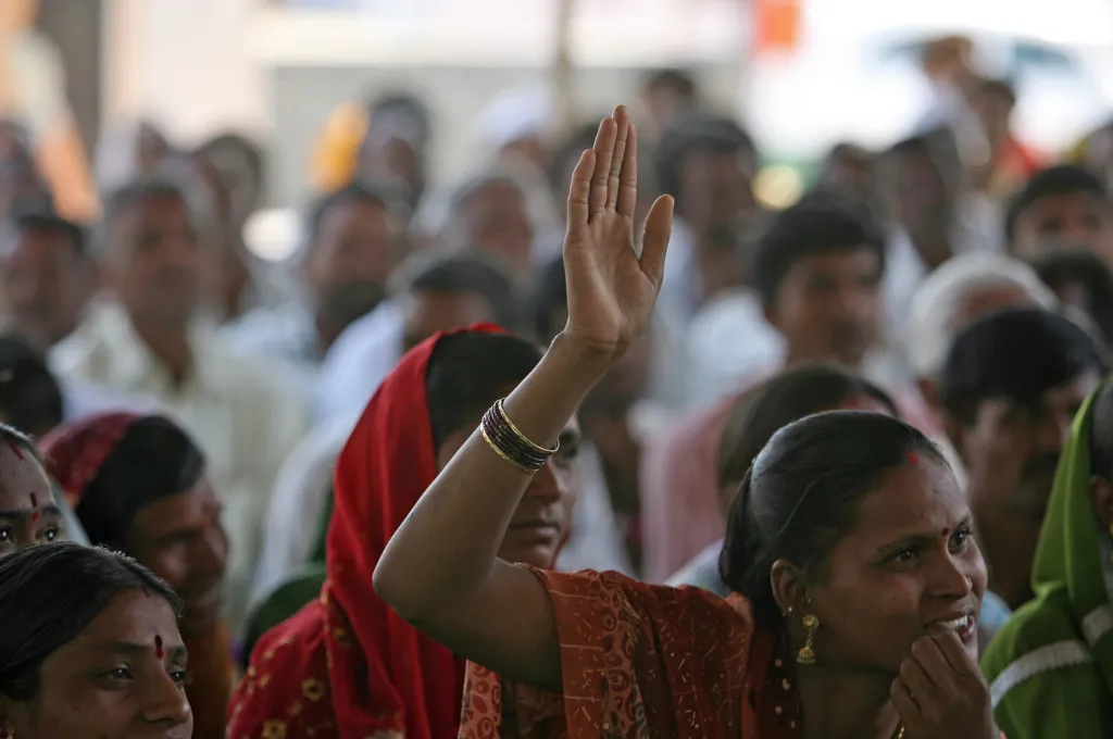 A woman raises her hand to speak at a community meeting in Aurangabad--unconference