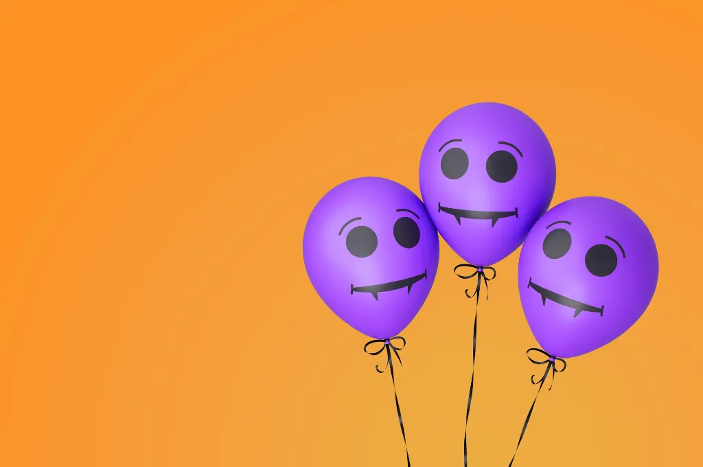 three purple balloons with dracula smiley faces against an orange background--nonprofit humour