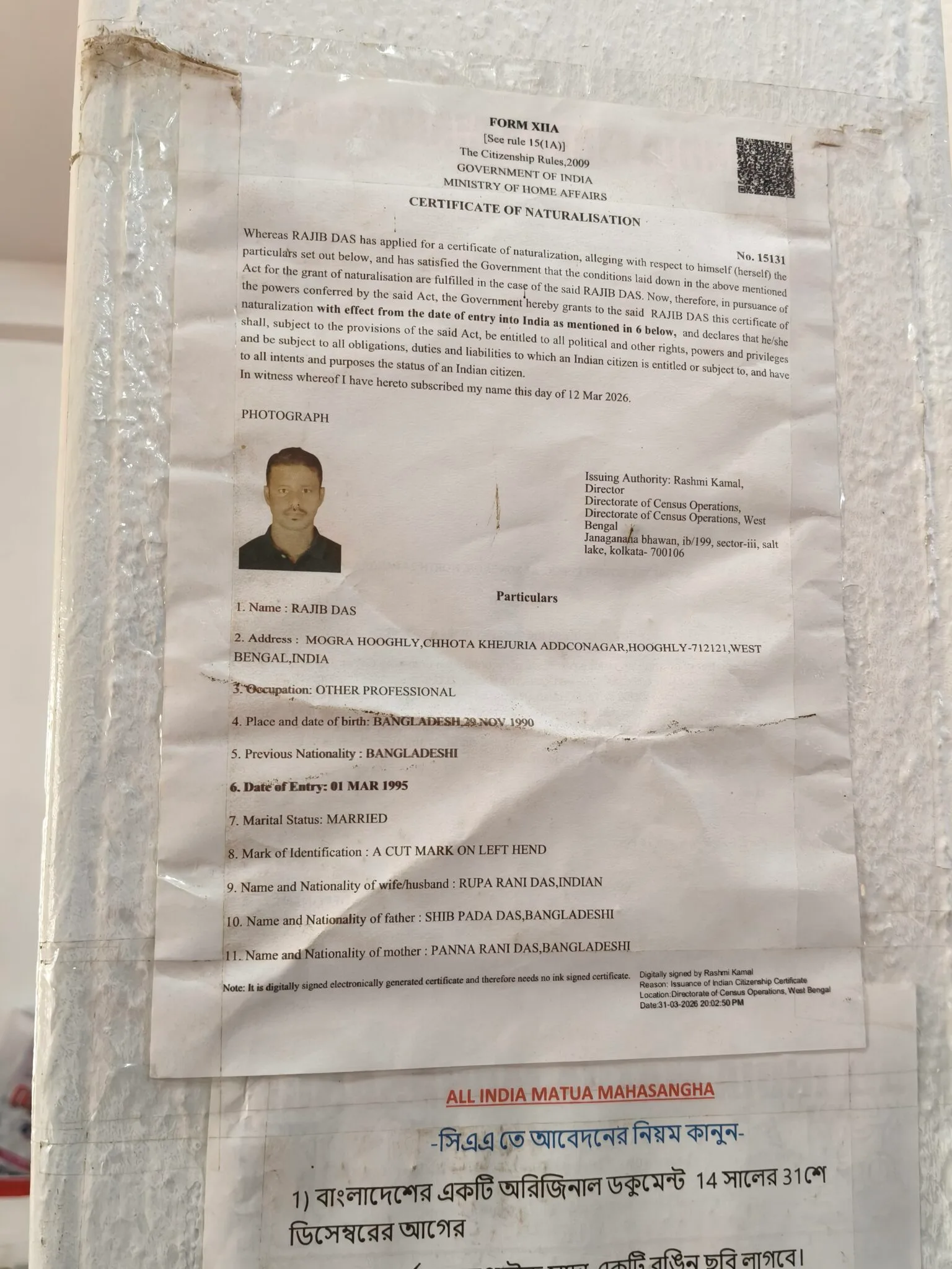 A specimen of a Certificate of Naturalisation stuck on a wall adjacent to a counter inside the CAA facilitation camp inside Thakurbari, Thakurnagar, North 24 Parganas, West Bengal.