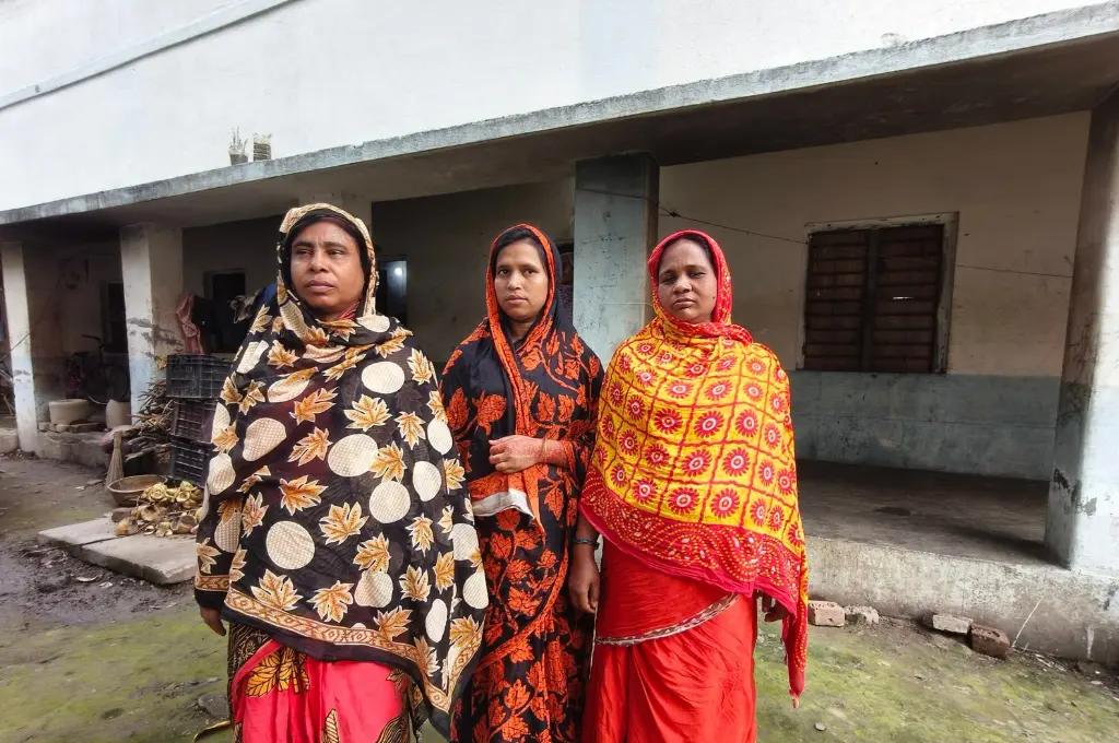 three women standing in front of a building--SIR