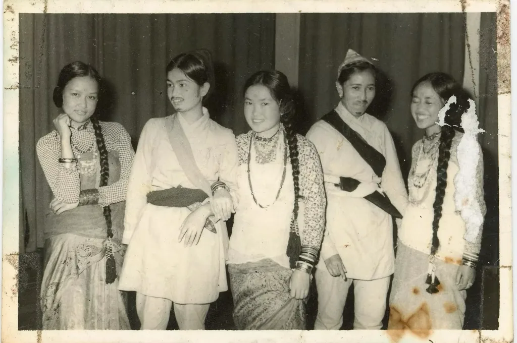 a black and white photograph of five young women, of whom two are dressed as boys--photo archive