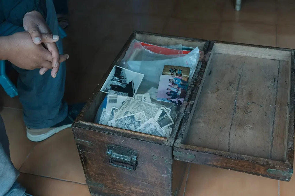 an old wooden trunk full of photographs wrapped in cellophane--photo archive
