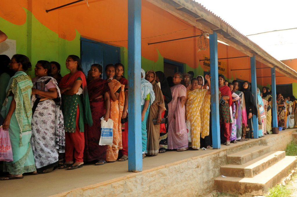 women standing in a queue in a corridor for voting--SIR