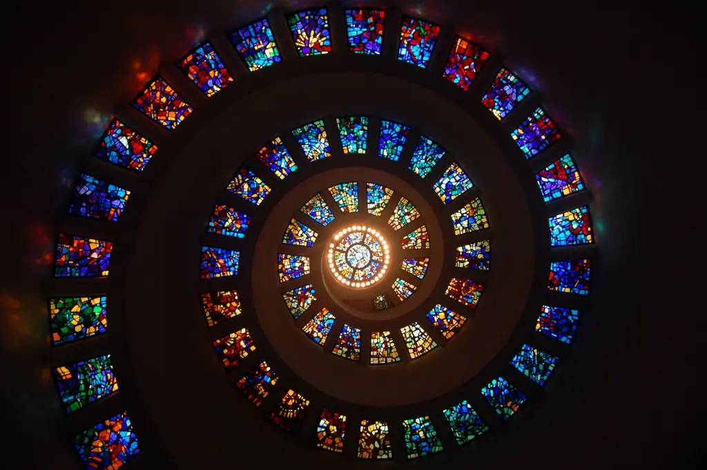 Colorful stained glass spiraling across a chapel ceiling--social sector